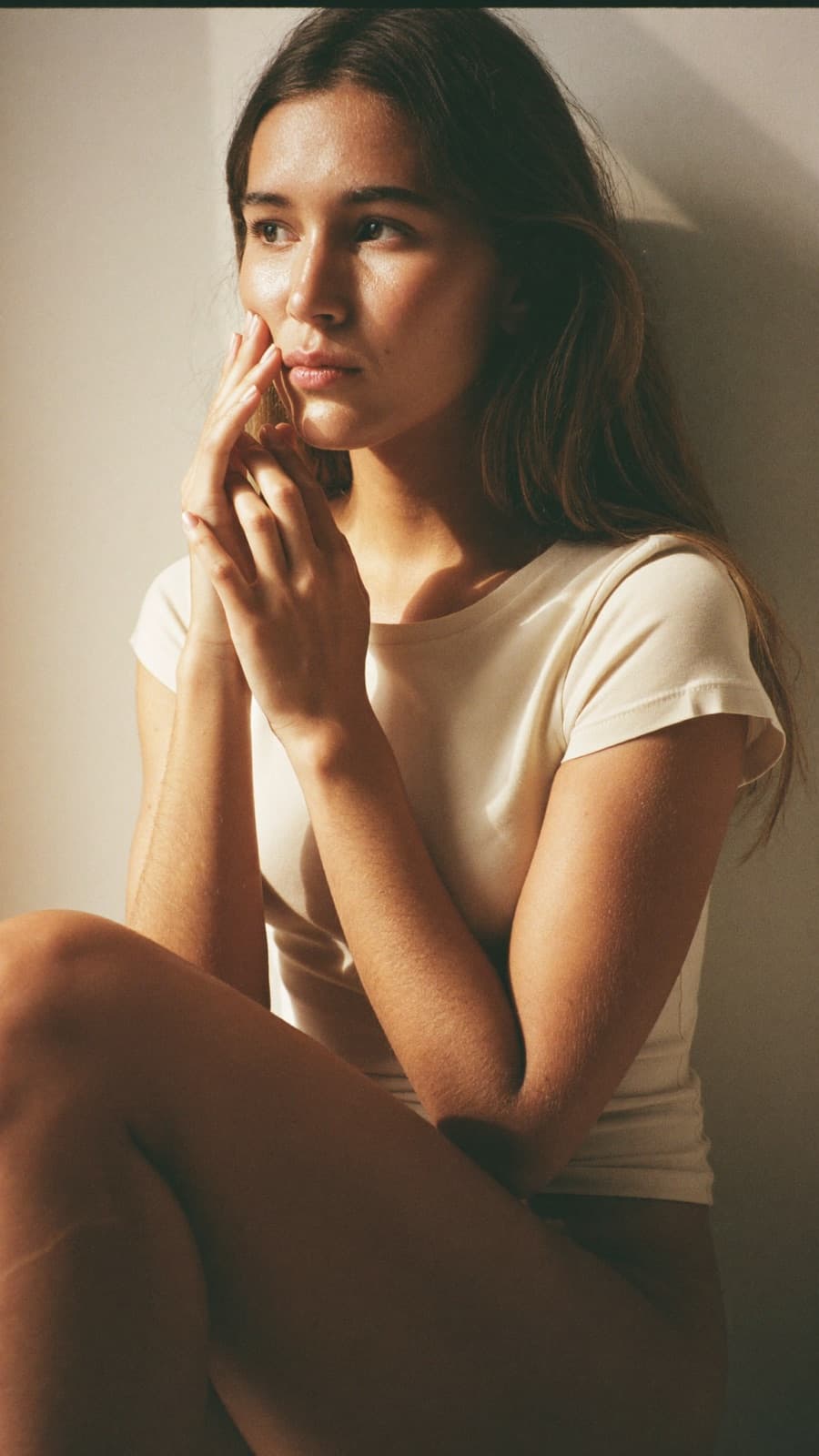 A woman in soft golden morning light in a calm getting-ready moment